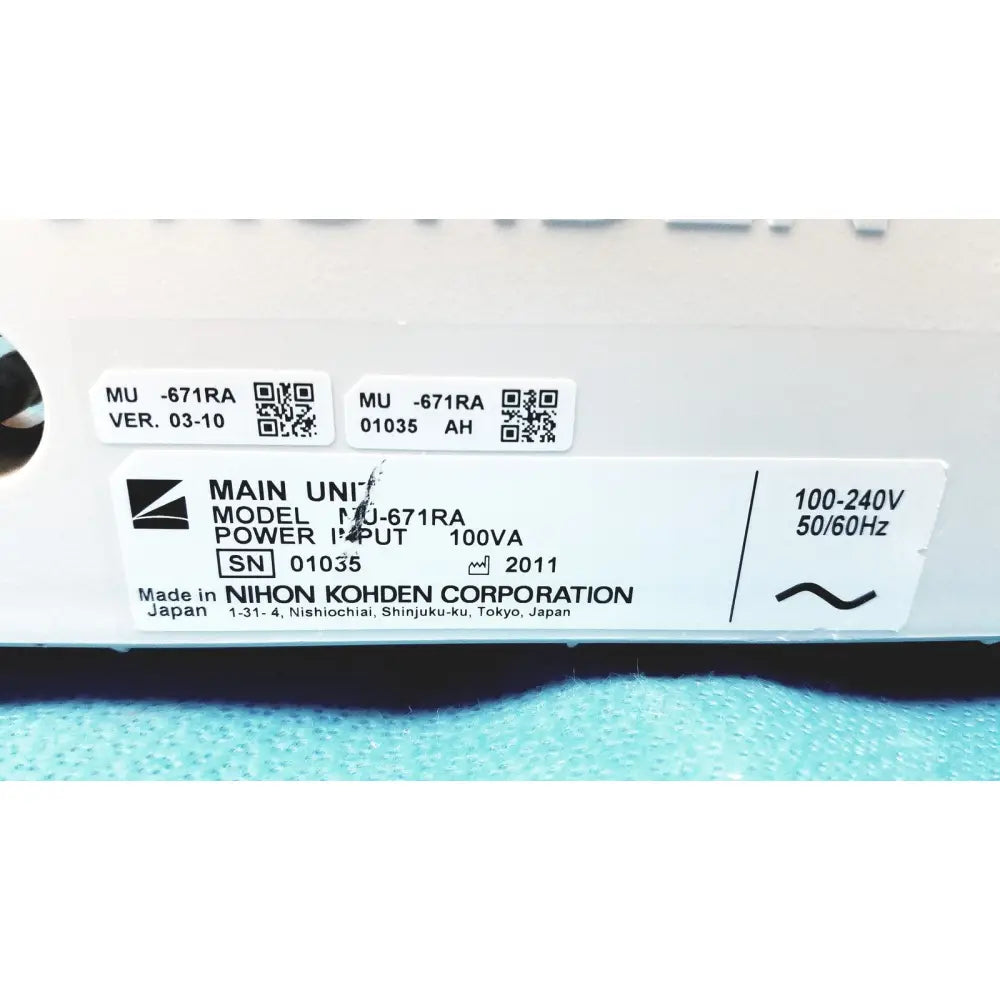 White plastic label with black text and qr codes on the back of nihon kohden lifescope bedside patient monitor power supply unit
