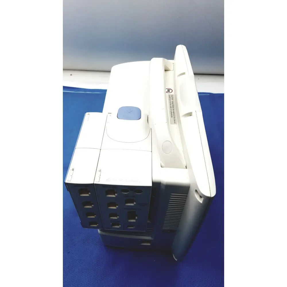 White and blue nihon kohden lifescope bedside patient monitor with sleek ergonomic design and multiple side ports
