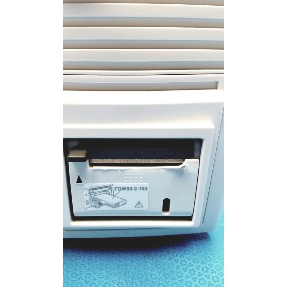 White plastic printer cartridge slot with black ink ribbon labeled fqw50-2-100 on nihon kohden lifescope bedside patient monitor