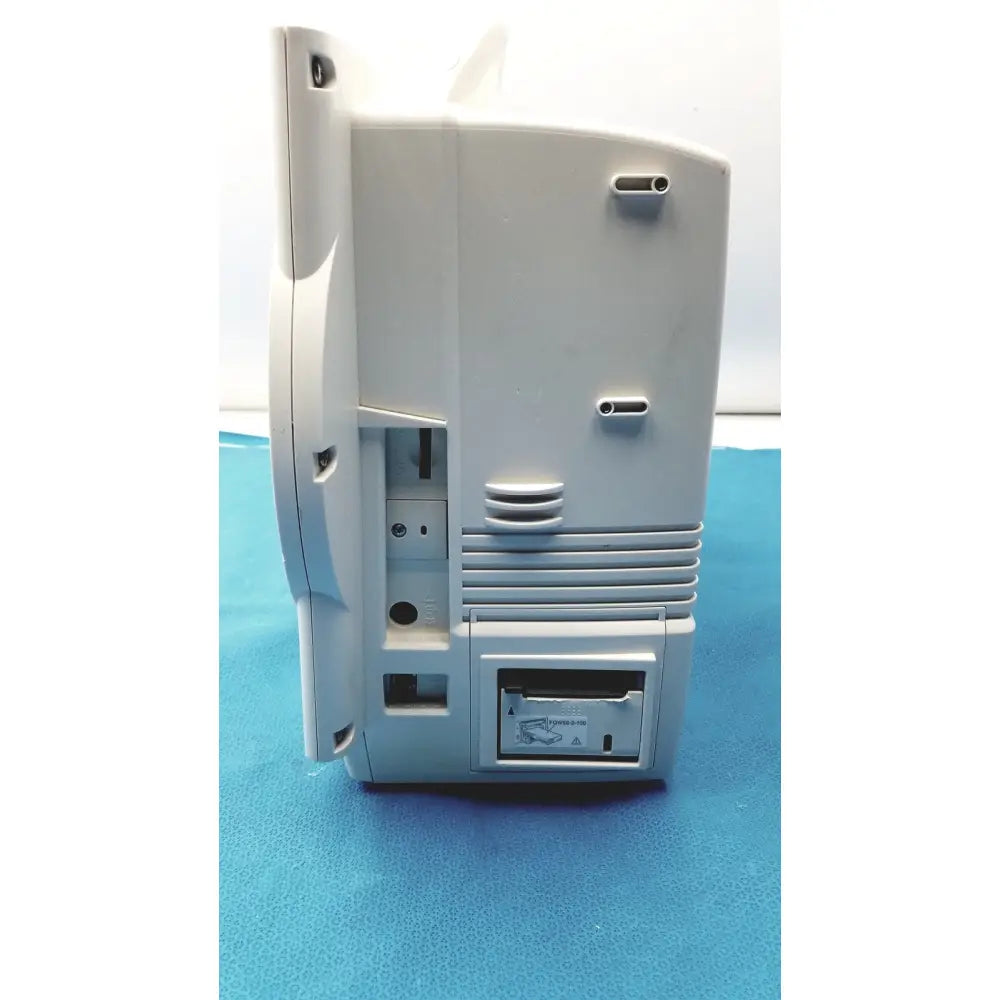 Light gray plastic back of nihon kohden lifescope bedside patient monitor with vertical cable slot and ventilation slats