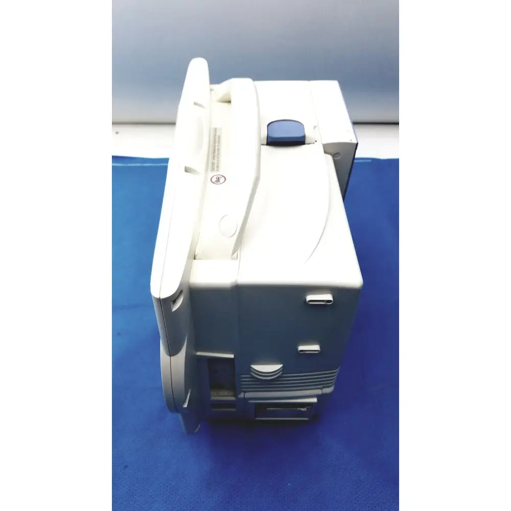 White and gray Nihon Kohden lifescope bedside patient monitor with a blue button on top for hospital use