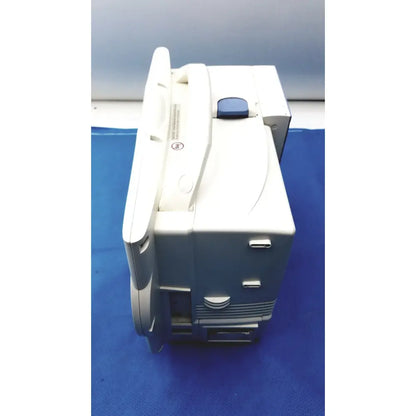 White and gray Nihon Kohden lifescope bedside patient monitor with a blue button on top for hospital use