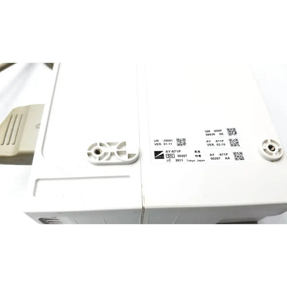 White plastic industrial component with molded tabs and qr code labels on the back of nihon kohden life scope bedside patient monitor