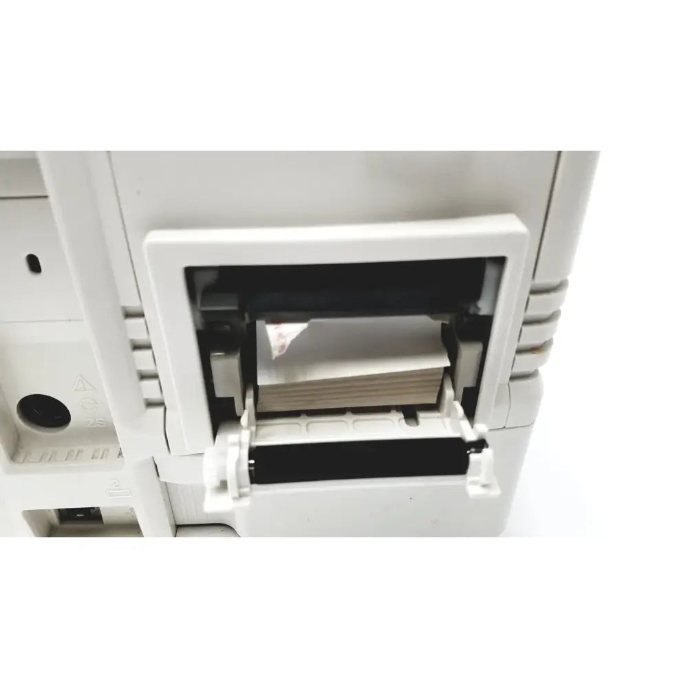 White plastic nihon kohden life scope bsm-6301a bedside patient monitor with open paper tray revealing stacked sheets