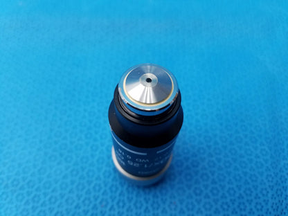 Black cylindrical microscope objective with silver metal top cap and central hole featuring numerical aperture for compatible Nikon microscope