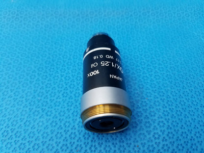 Black and silver Nikon 100x oil microscope objective with gold threading, numerical aperture 1.25, compatible Nikon microscope