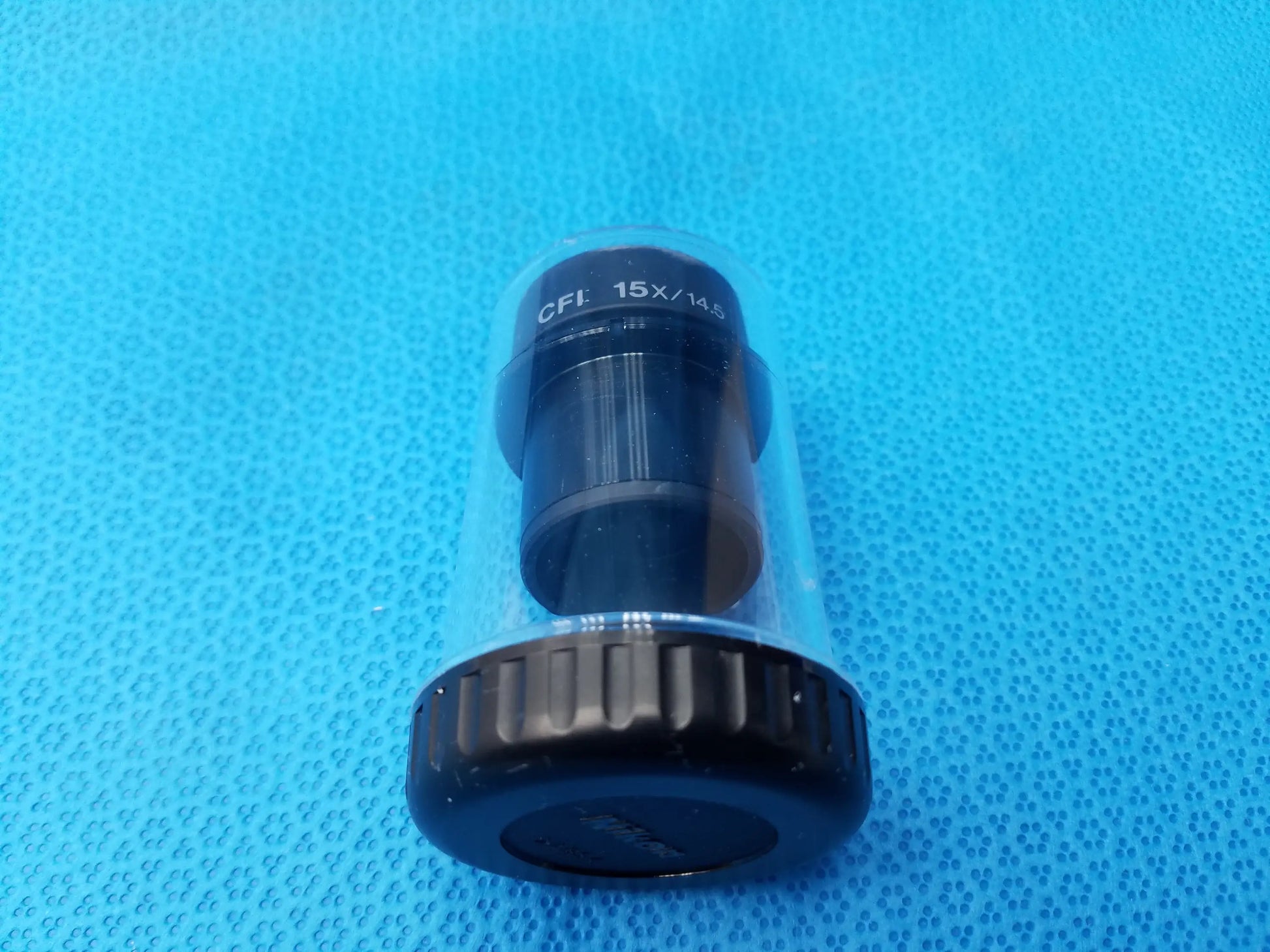 Nikon CFI 15x black cylindrical microscope eyepiece with field number 14.5 in clear protective storage case