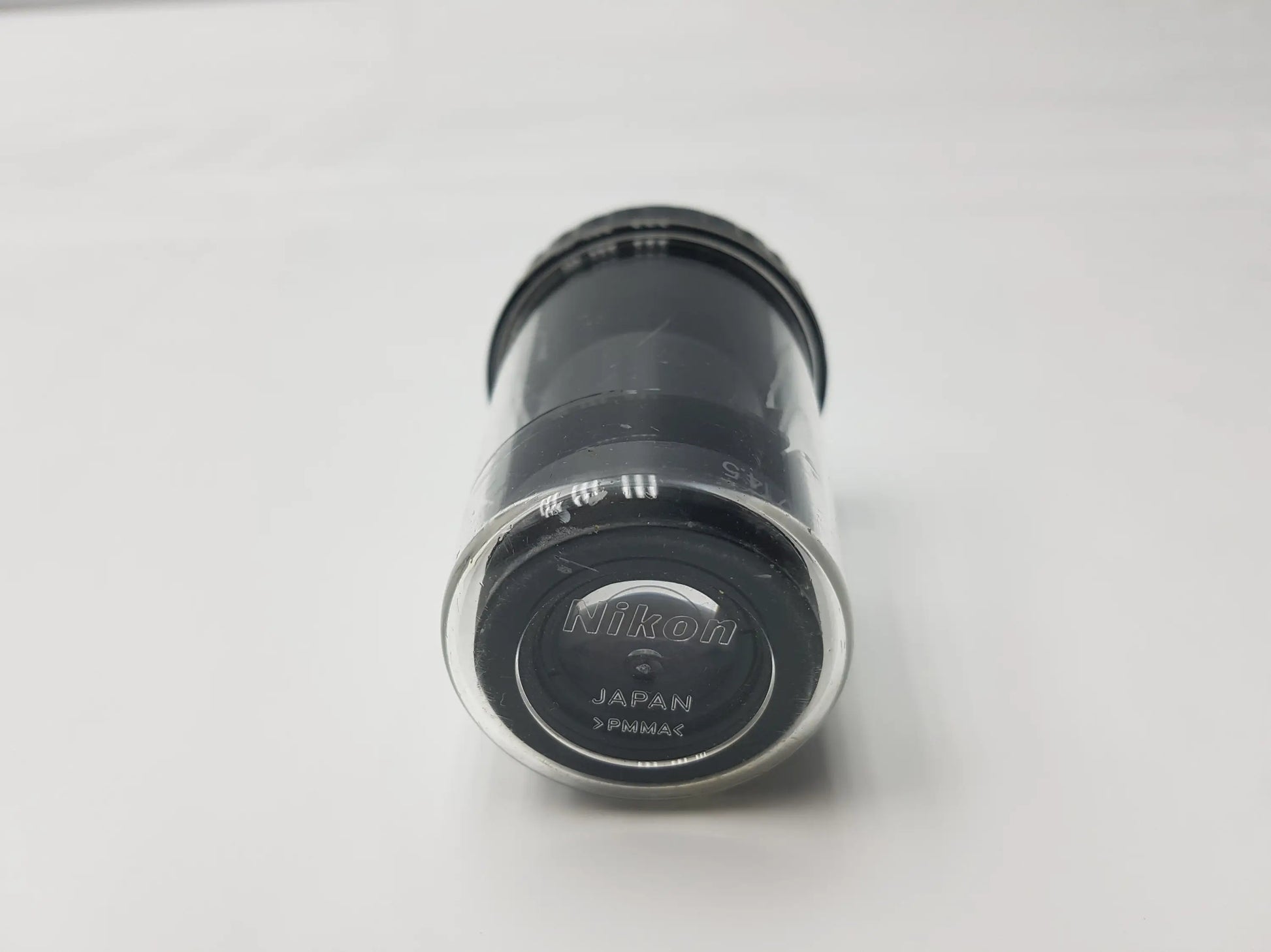 Black Nikon CFI 15x 14.5 microscope eyepiece with clear protective cap marked Japan and Fujinon and storage case compatible Nikon microscope systems