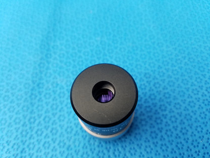 Black cylindrical nikon e plan microscope objective with purple internal element and blue numerical aperture labeling