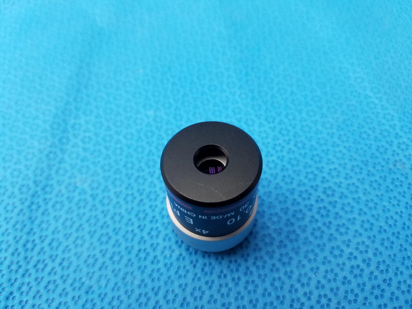 Black and silver nikon e plan microscope objective lens with 4x and 10x numerical aperture markings for precision use