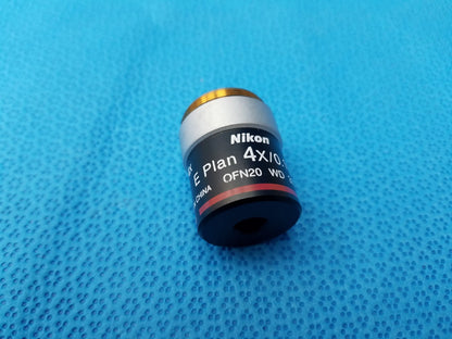 Nikon e plan 4x microscope objective with numerical aperture 0.10 features a silver metal body and gold threaded top