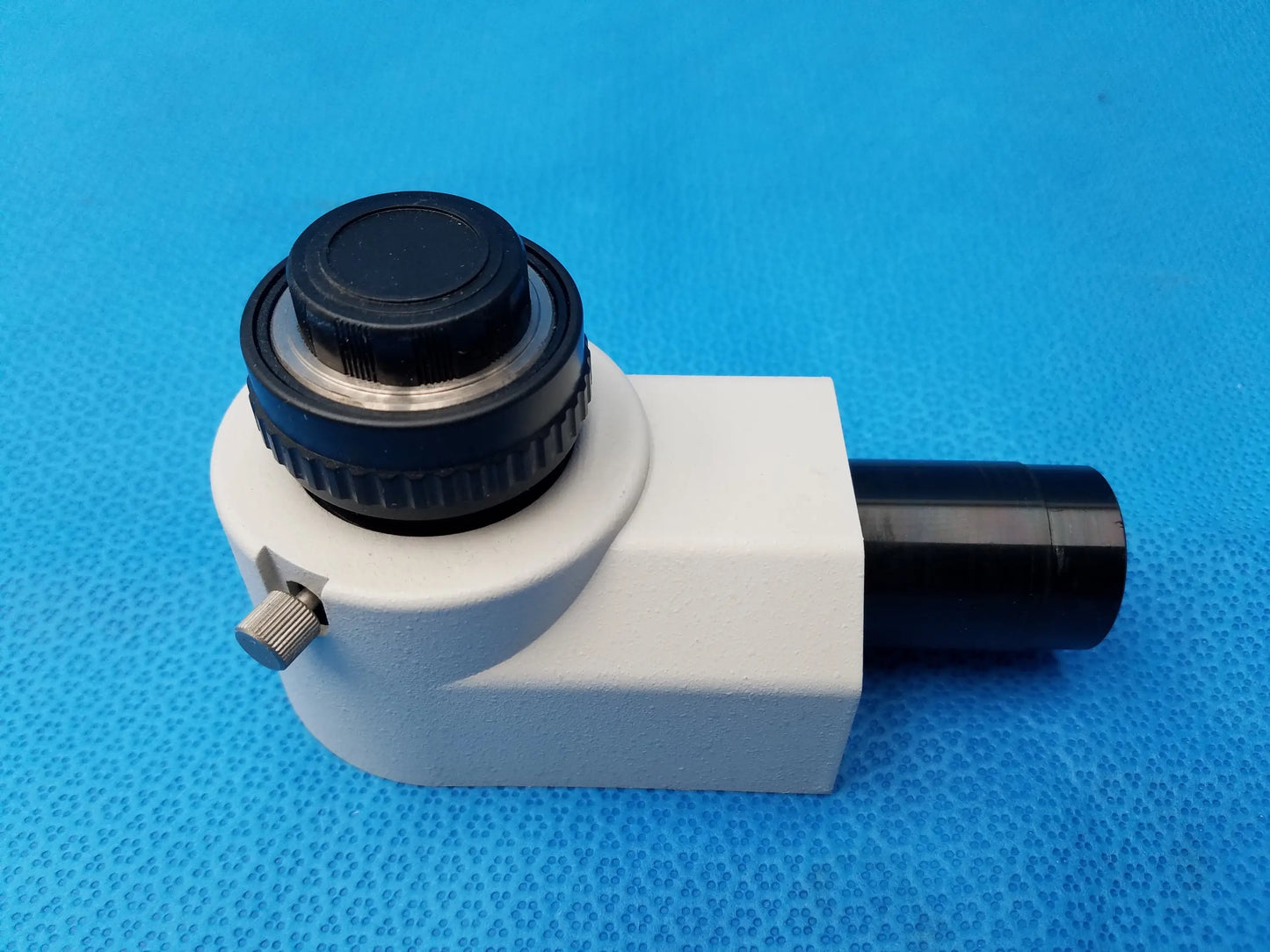 White and black Nikon microscope camera adapter with textured knob and metallic adjustment screw for compatible Nikon microscopes