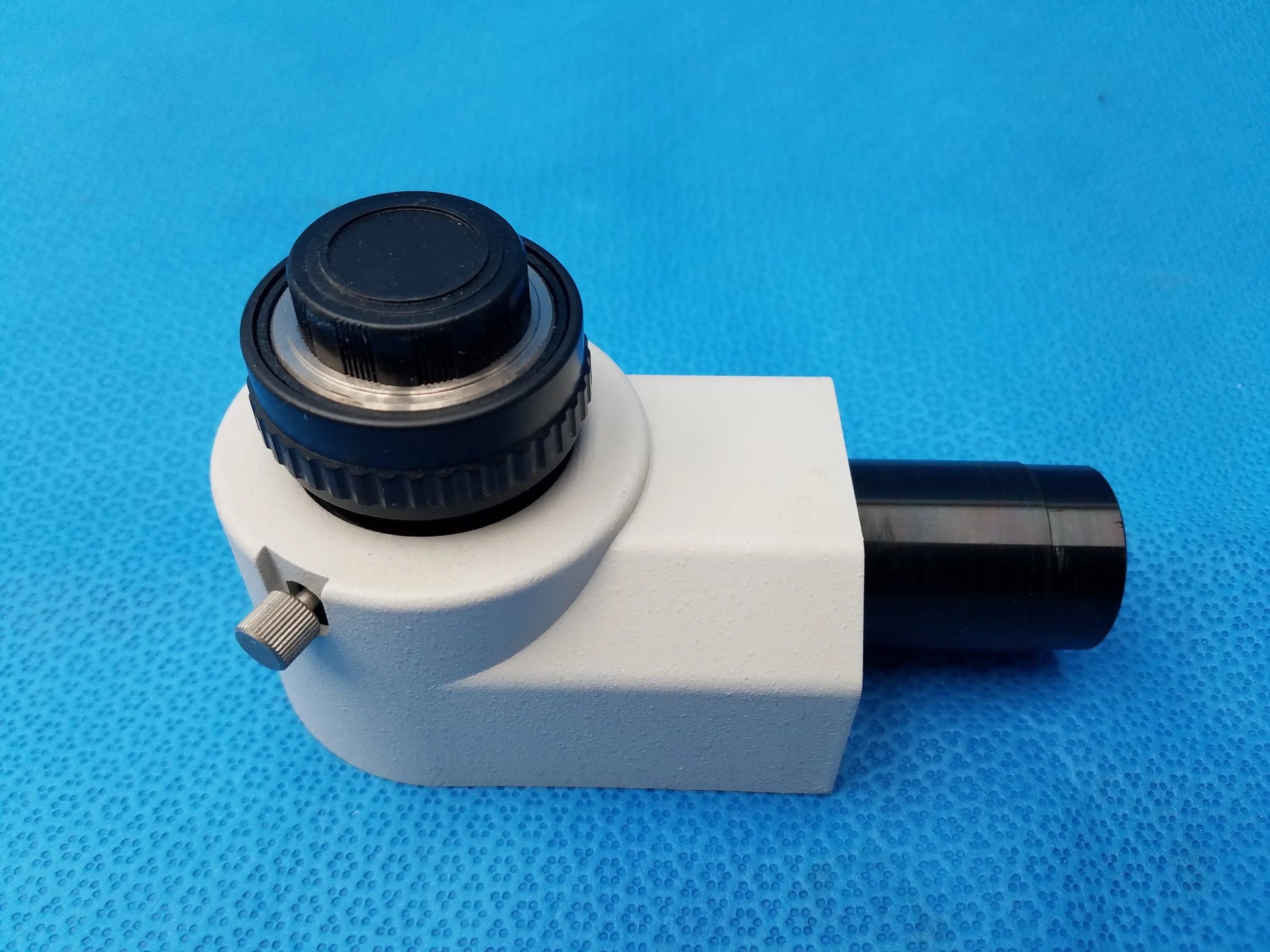 White and black Nikon microscope camera adapter with textured knob and metallic adjustment screw for compatible Nikon microscopes