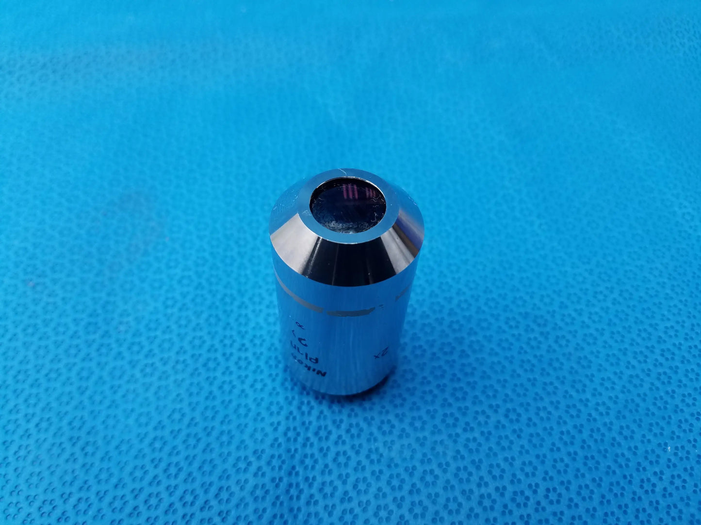 Chrome-finished nikon plan 2x microscope objective lens with black aperture and engraved markings for compatible nikon microscope systems