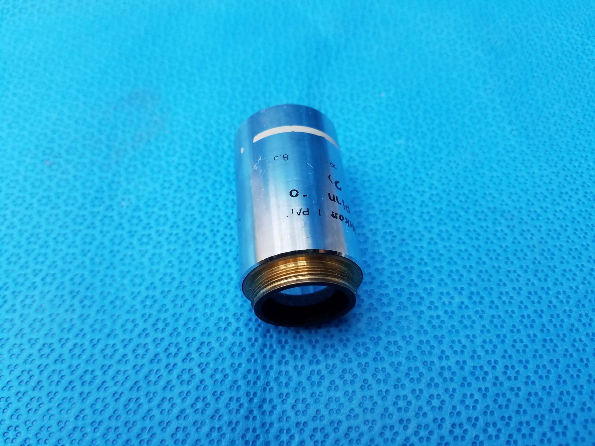 Nikon Plan 2x microscope objective with silver metallic lens and gold threaded base for compatible Nikon microscope systems