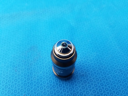 Blue cylindrical microscope objective with metallic silver top and engraved markings for nikon microscope systems