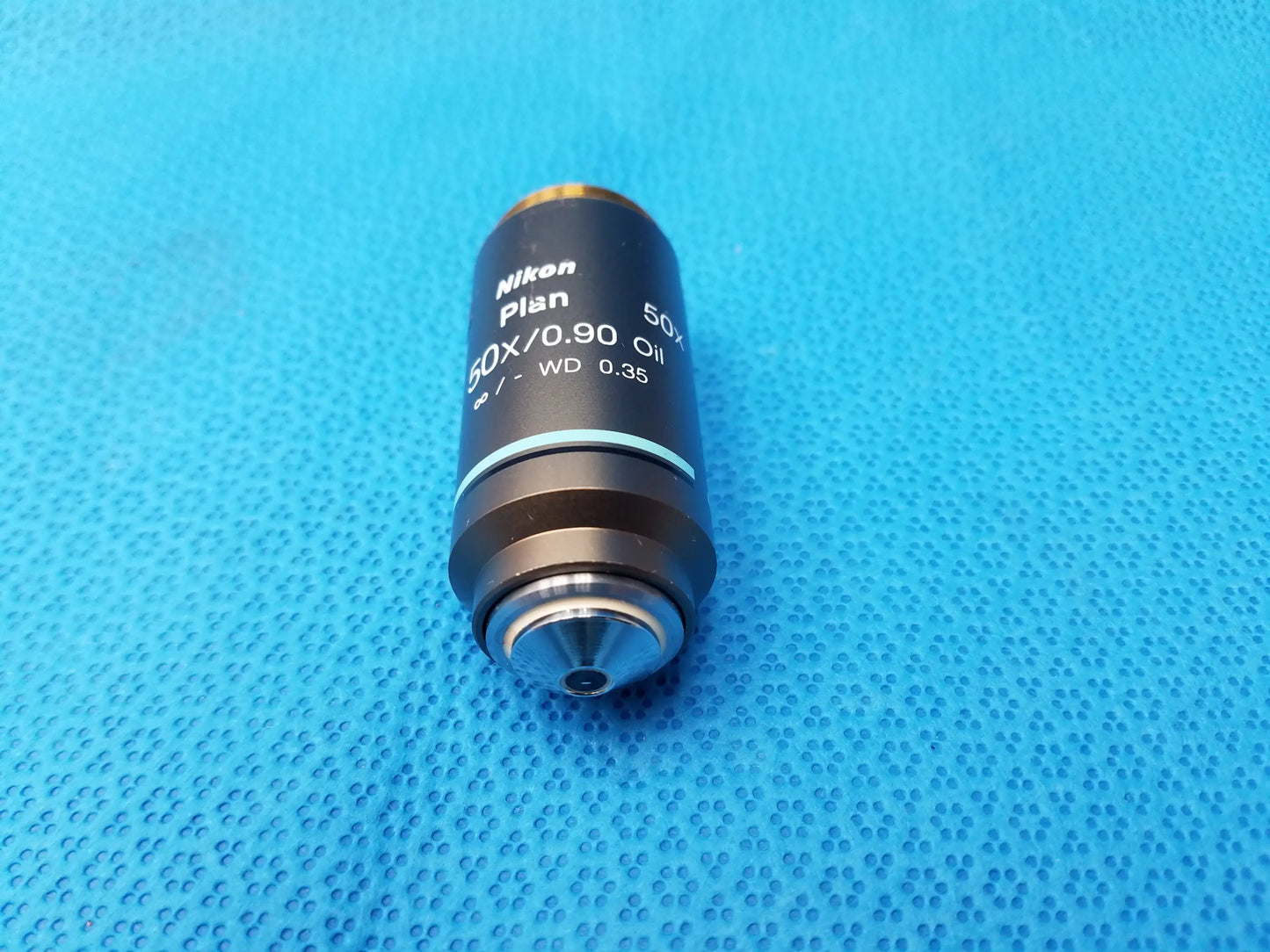 Nikon plan 50x/0.90 oil microscope objective with black body and silver threading for compatible Nikon high-magnification use