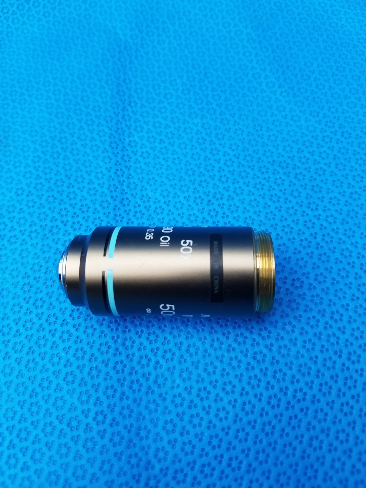 Black and gold nikon plan 50x microscope objective lens marked 50x oil compatible nikon for oil immersion use