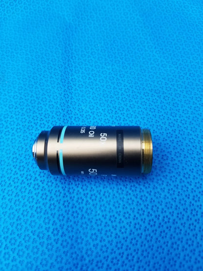 Black and gold nikon plan 50x microscope objective lens marked 50x oil compatible nikon for oil immersion use