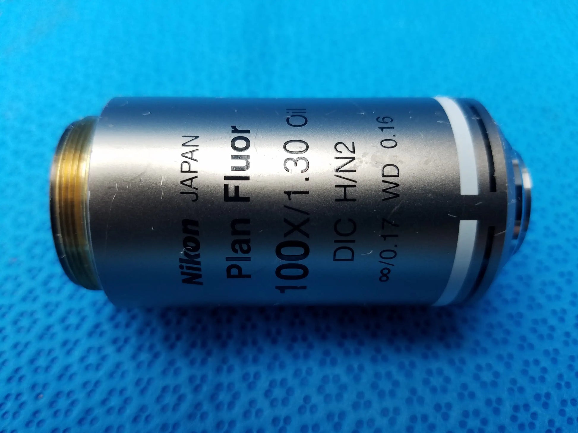 Nikon plan fluor 100x 1.30 oil microscope objective with metallic silver body and gold threaded mount compatible Nikon