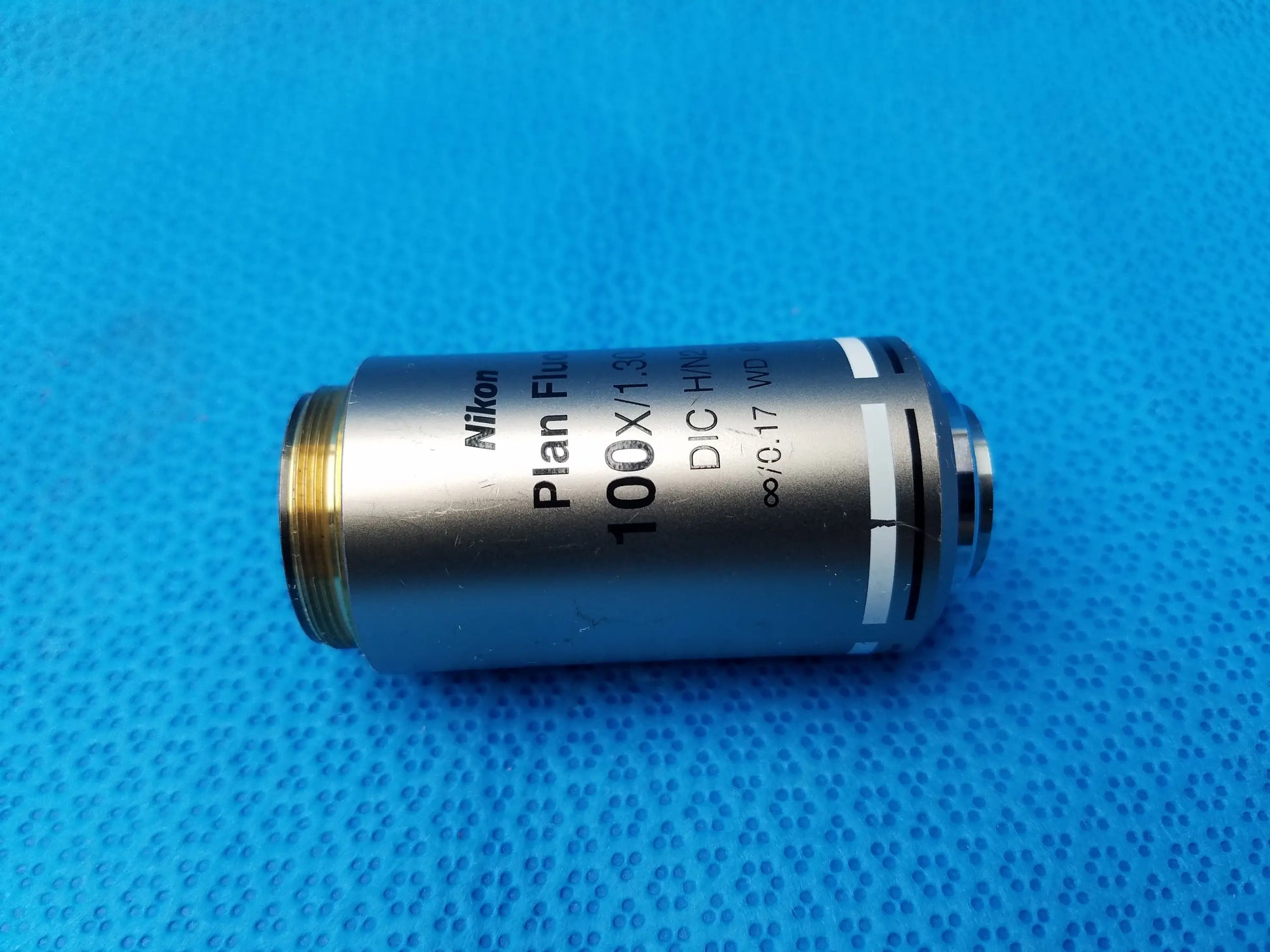 Nikon plan fluor 100x 1.3 microscope objective with silver body and gold threaded mount compatible Nikon models