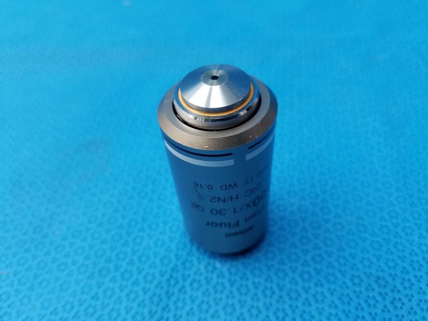 Silver cylindrical plan fluor microscope objective with metallic top cap and engraved specifications compatible nikon model