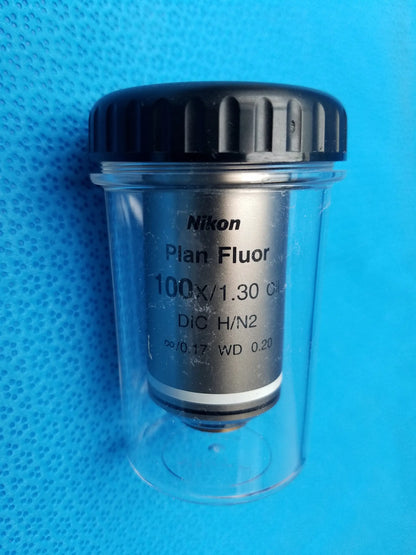 Nikon plan fluor 100x 1.30 microscope objective lens in clear protective case with black ribbed cap compatible Nikon