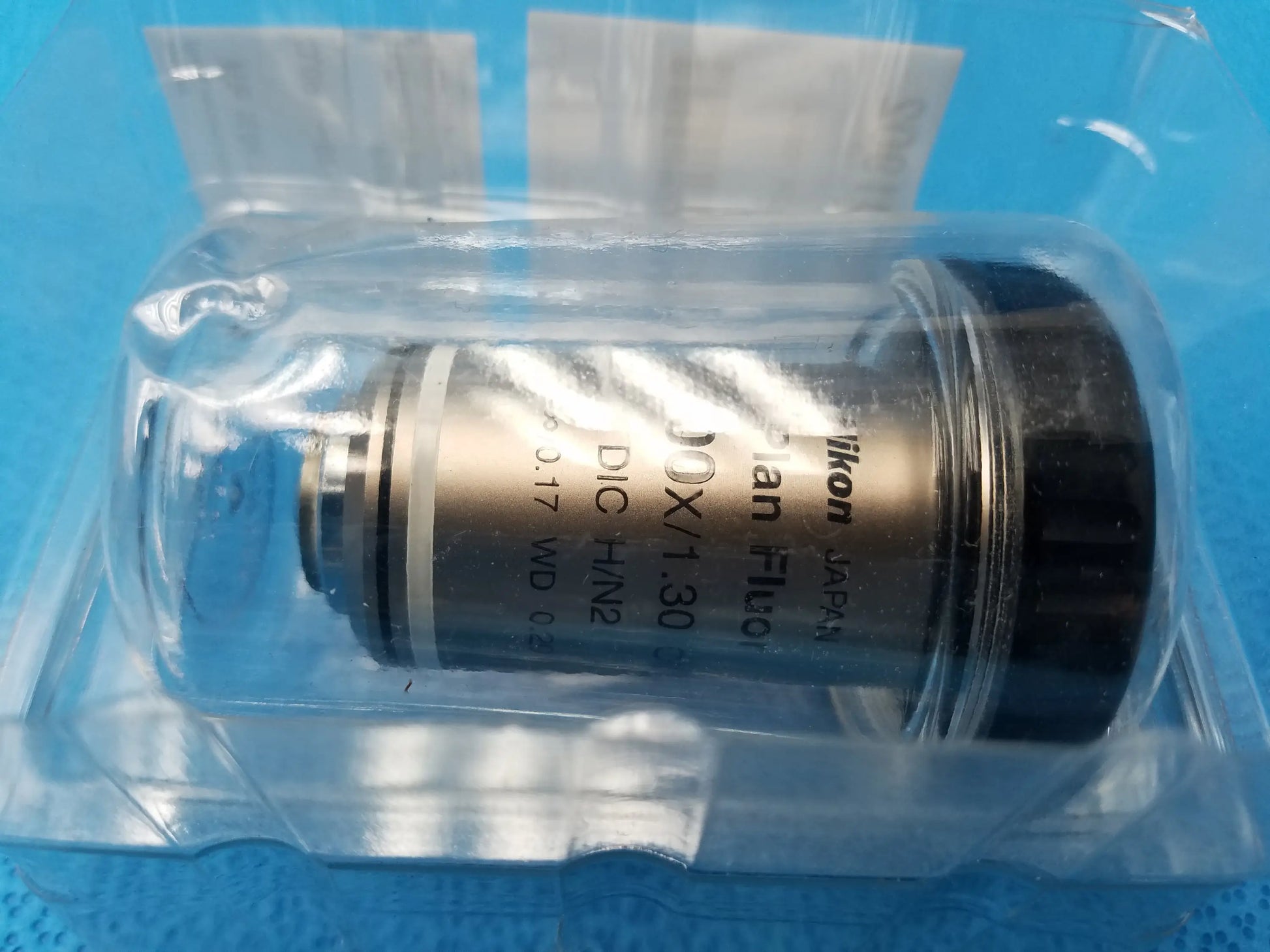 Nikon plan fluor microscope objective with metallic body and black cap labeled 1.30x compatible Nikon DIC HN2 lens
