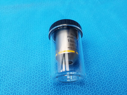 Silver Nikon plan fluor microscope objective with black cap yellow band and 16mm working distance in clear case