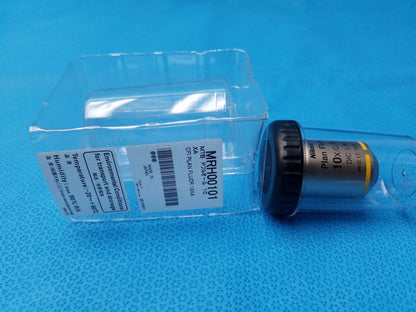 Nikon plan fluor 10x/0.30 microscope objective lens with yellow ring and 16 mm working distance on blue surface