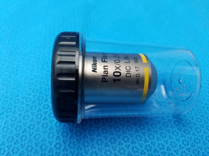 Nikon plan fluor microscope objective lens with black knurled focusing ring silver body and 16mm working distance in clear tube