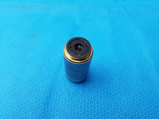 Silver Nikon plan fluor microscope objective lens with gold-colored rim and black top ring compatible Nikon models
