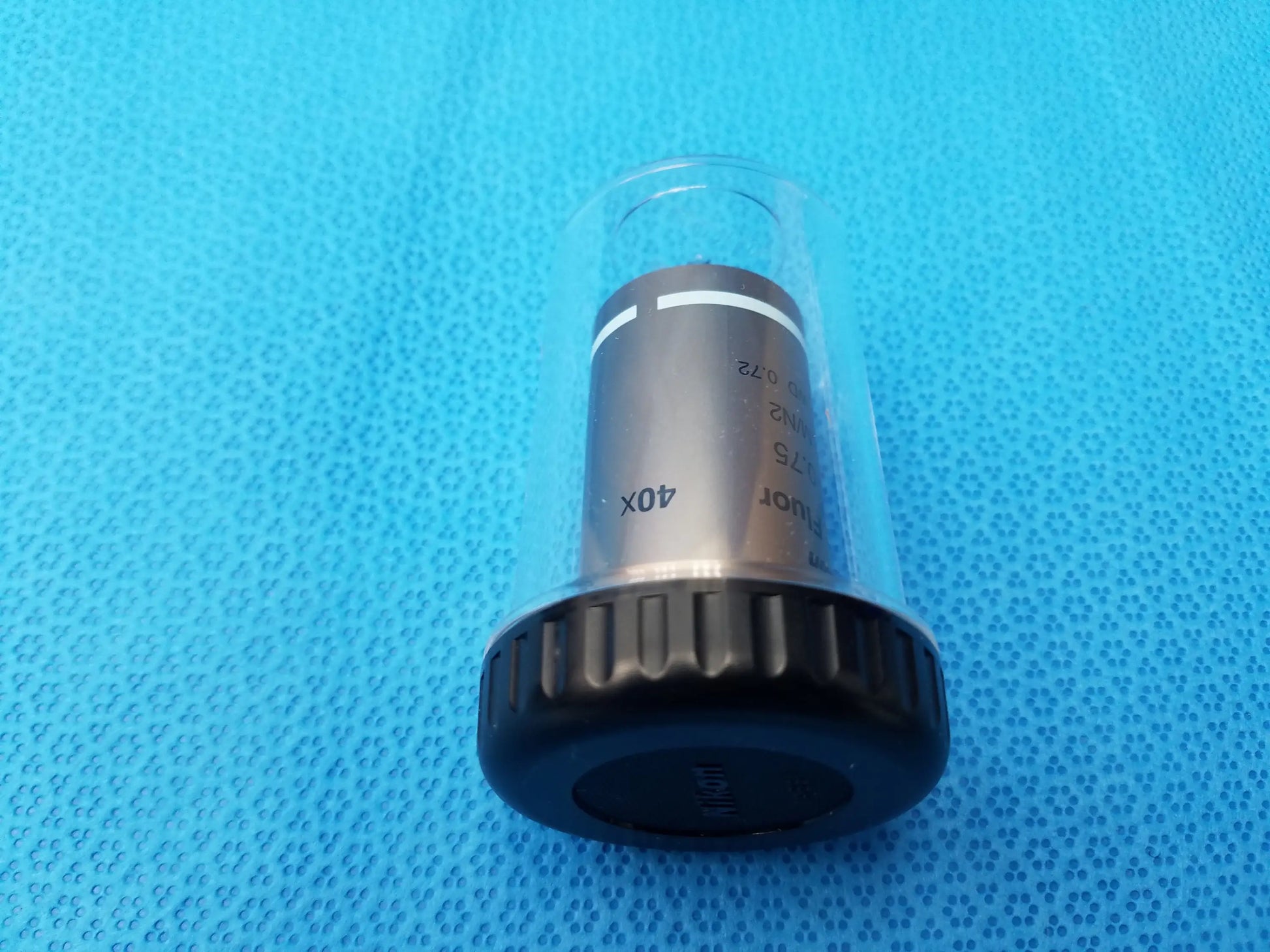 Nikon plan fluor 40x microscope objective lens in black and silver with textured grip in clear protective casing compatible Nikon