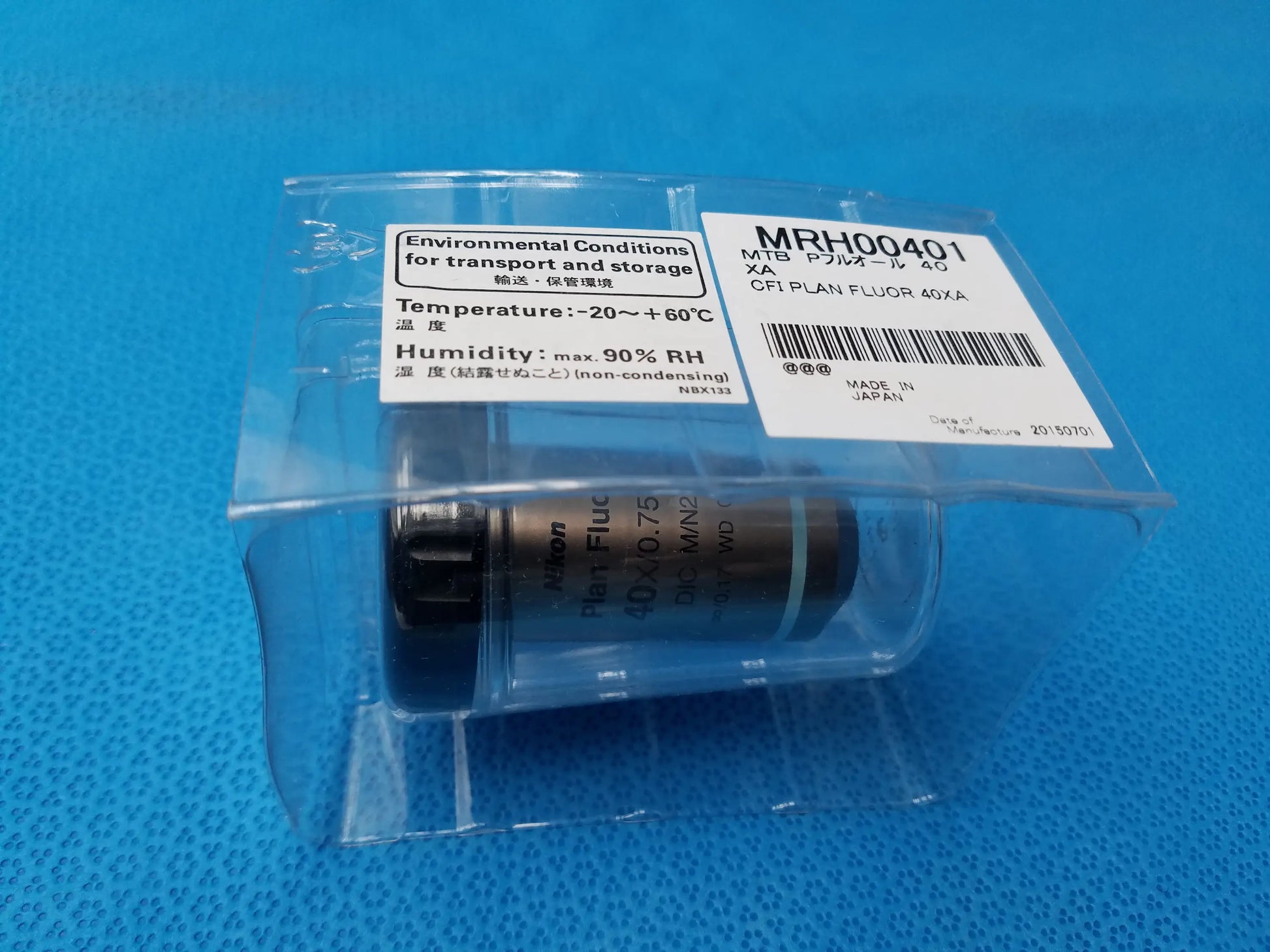 Black and silver plan fluor microscope objective compatible Nikon in clear plastic labeled cfi plan fluor 40xa mrh00401