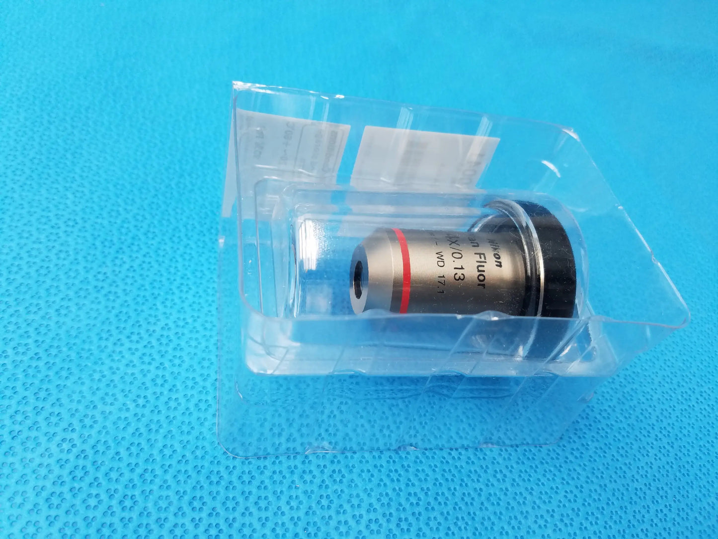 Nikon plan fluor metallic microscope objective with black threaded cap and red ring compatible Nikon model MRH00041