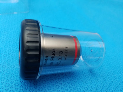 Nikon plan fluor 4x microscope objective with black textured focus ring silver body and red stripe compatible Nikon