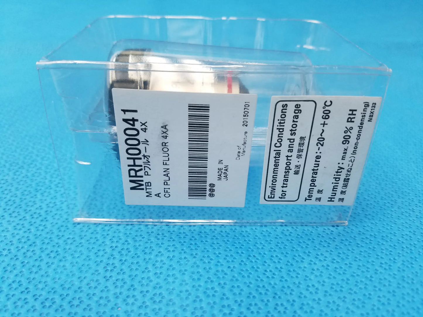 Silver rectangular nikon plan fluor 4x microscope objective lens with white labeling in clear plastic packaging compatible nikon