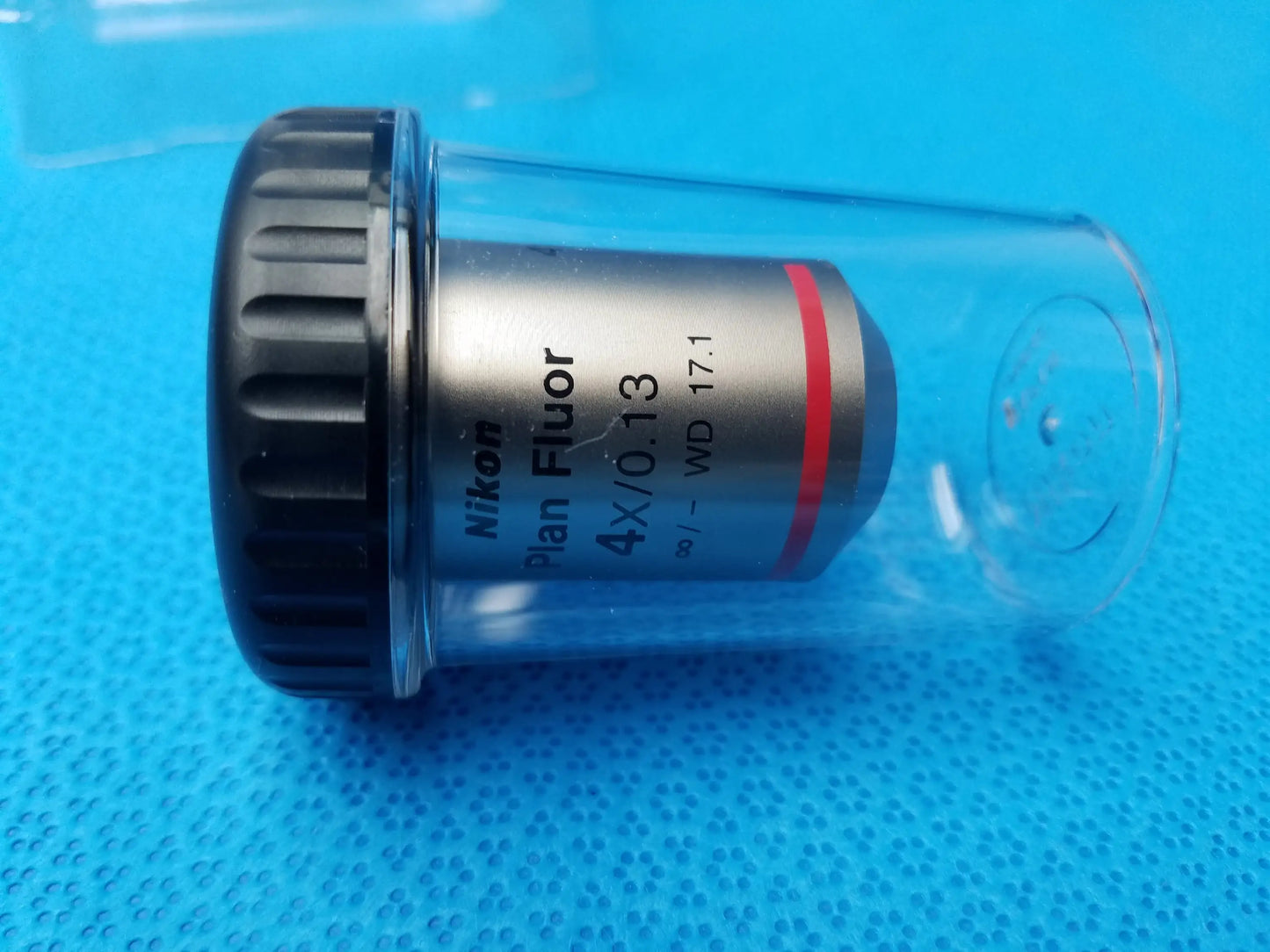 Nikon plan fluor microscope objective 4x 0.13 with silver body black textured ring in clear protective tube compatible Nikon