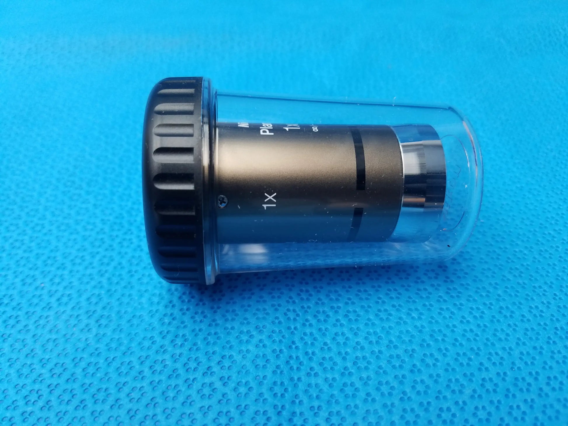 Black nikon plan uw 1x microscope objective with textured grip and clear casing for compatible nikon microscope systems