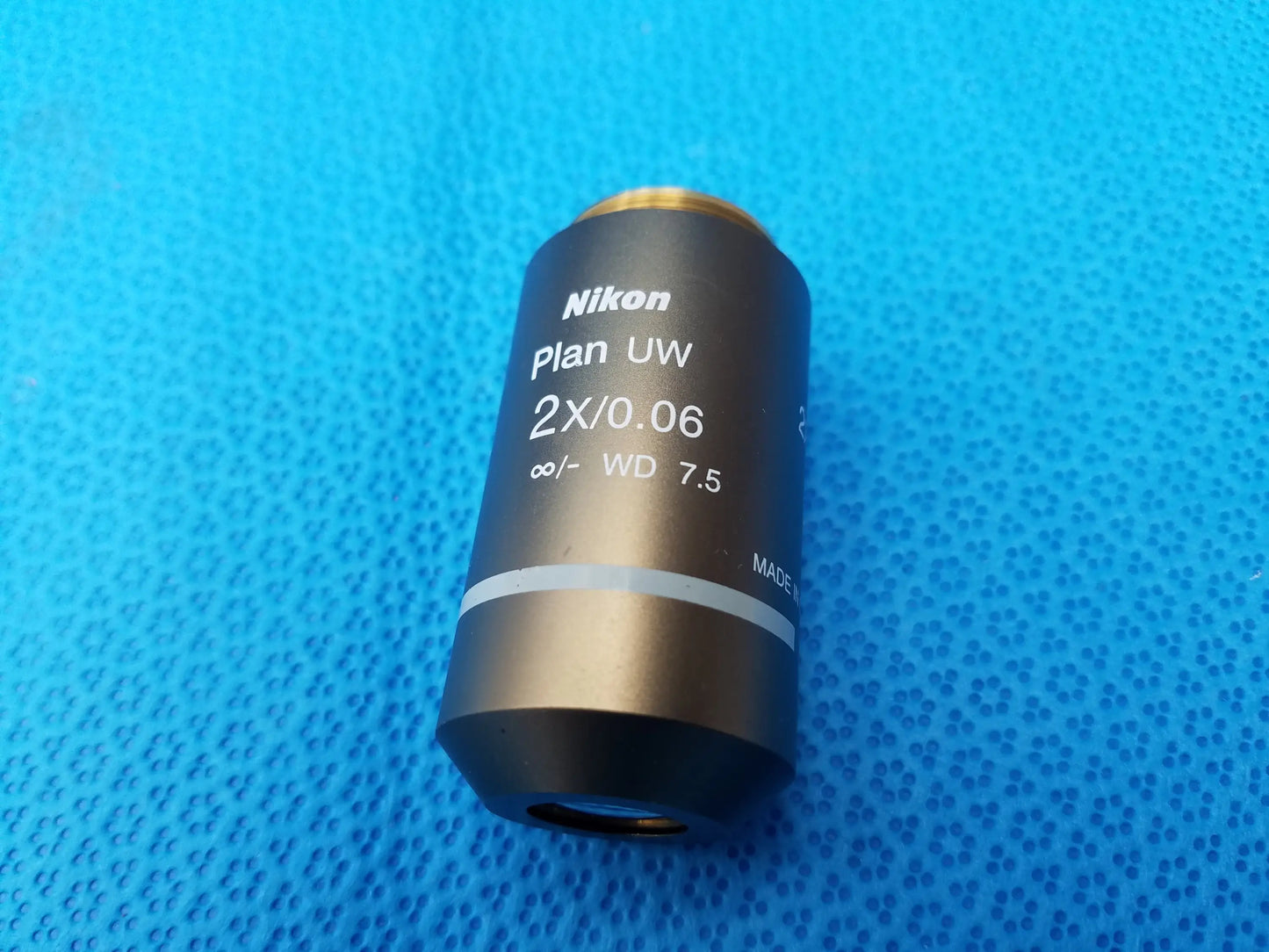 Nikon Plan UW 2x/0.06 microscope objective with gold top ring featuring numerical aperture and 7.5 mm working distance