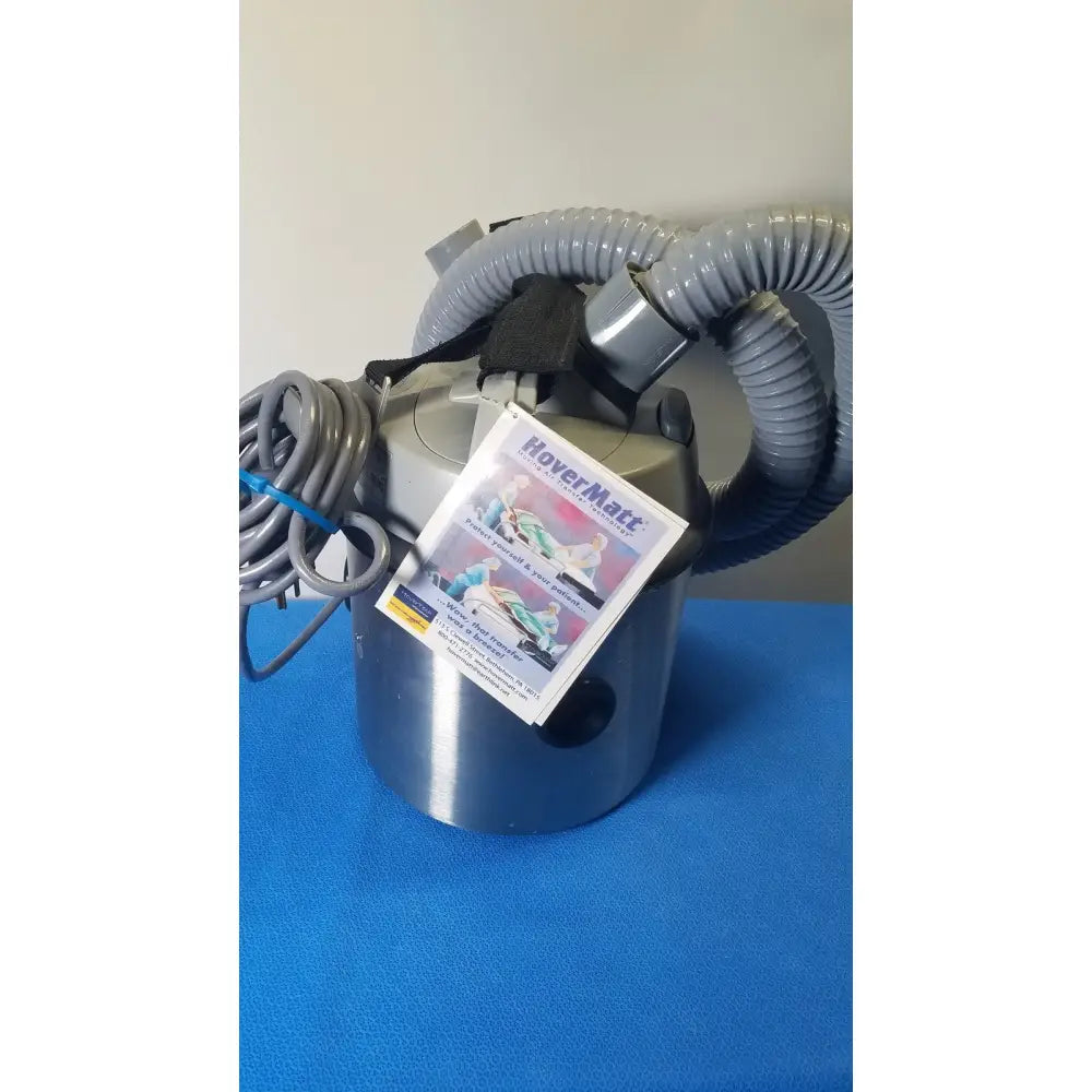 Silver metallic nilfisk advance hovermatt air supply unit with gray corrugated hoses and coiled power cord 110-120v 800w