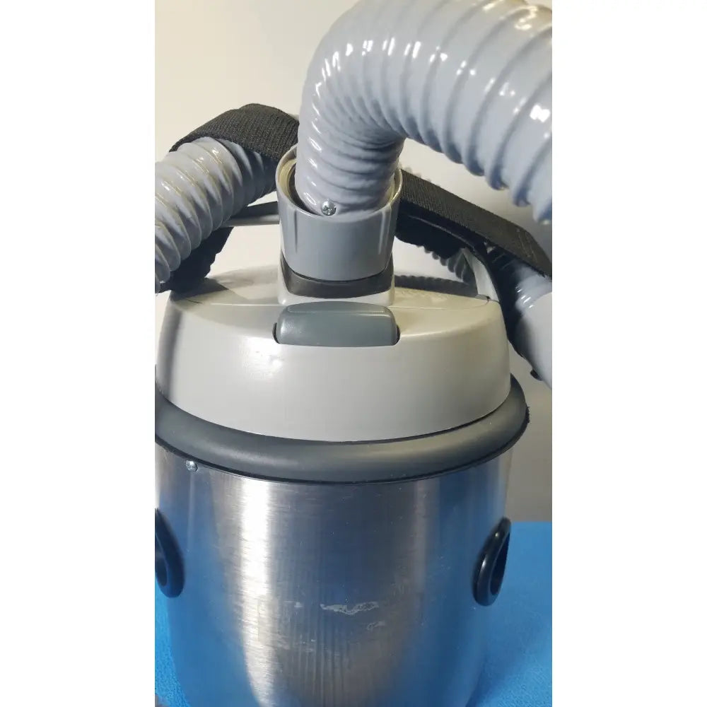 Gray and silver nilfisk hovermatt air supply unit with flexible corrugated hose for efficient portable vacuum cleaning