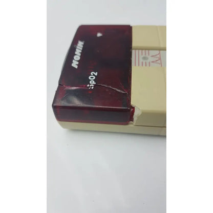 Worn translucent red and beige nonin spo2 handheld pulse oximeter model 8500m with visible cracks on casing