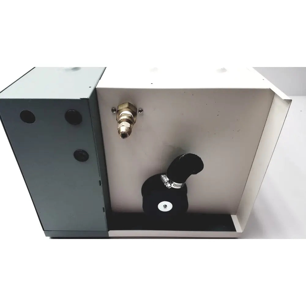 Back side of nortec humidifier nhtc showing black rubber hose with metallic clamp and brass fitting on gray metal box