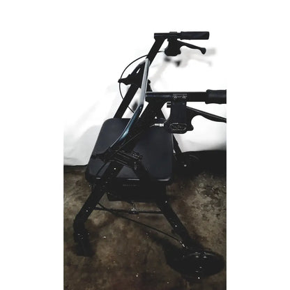 Black metal nova lightweight transport chair with padded seat handlebars and 12 inch rear wheels for 300lbs capacity