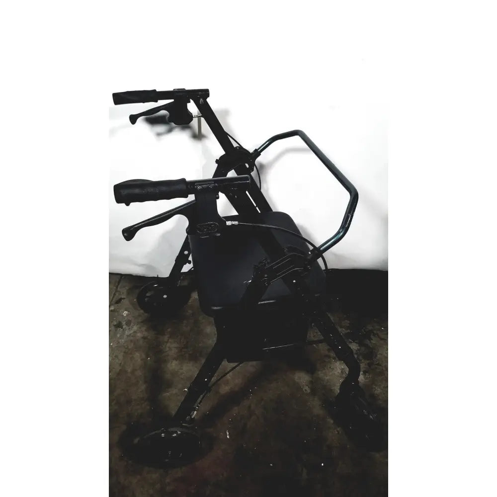 Black metal nova lightweight transport chair with padded seat and four wheels for easy mobility and 300lbs capacity