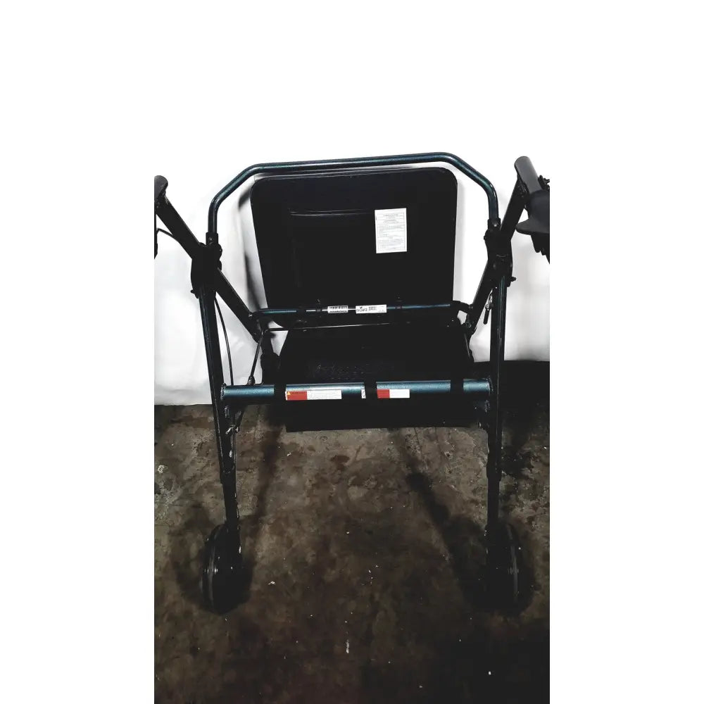 Black metal nova lightweight transport chair with four wheels and padded seat, 300lbs capacity, 12 inch rear wheels
