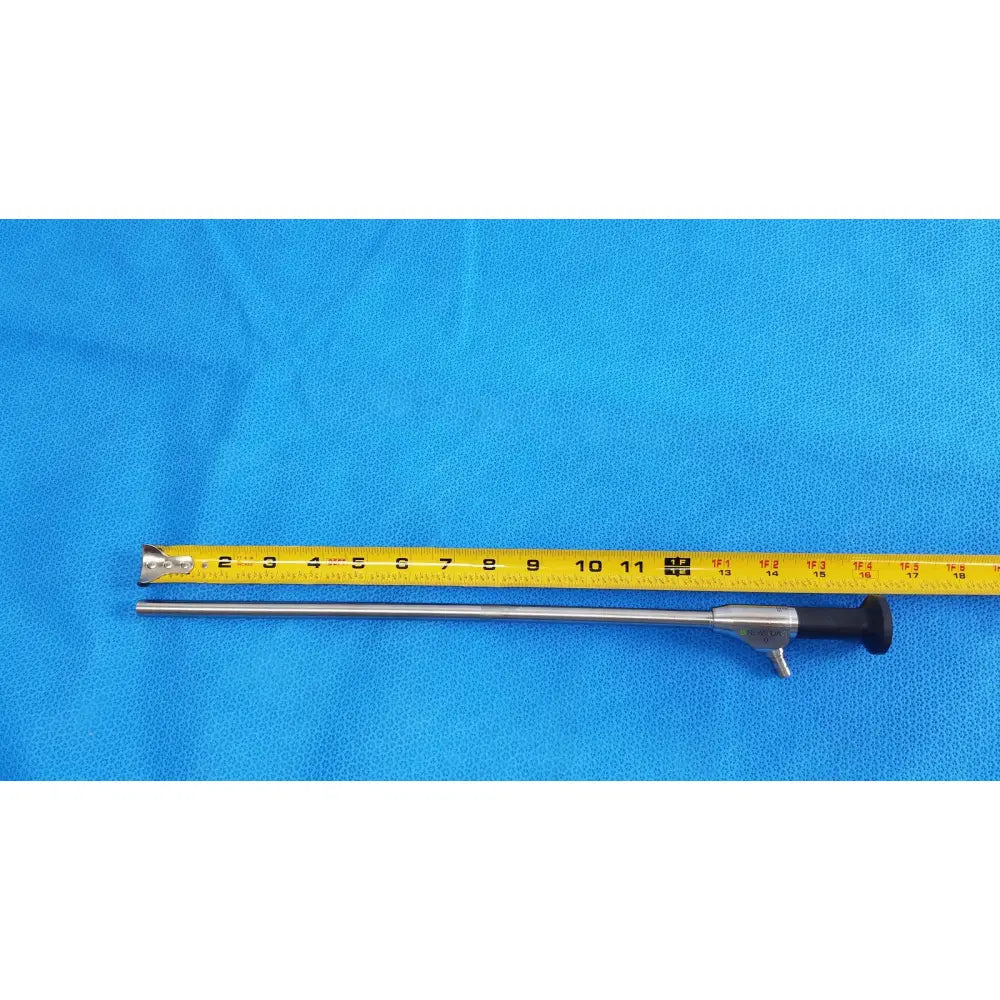 Silver novadaq sc9104 autoclavable laparoscope endoscope with black ergonomic handle and metallic shaft on blue surface
