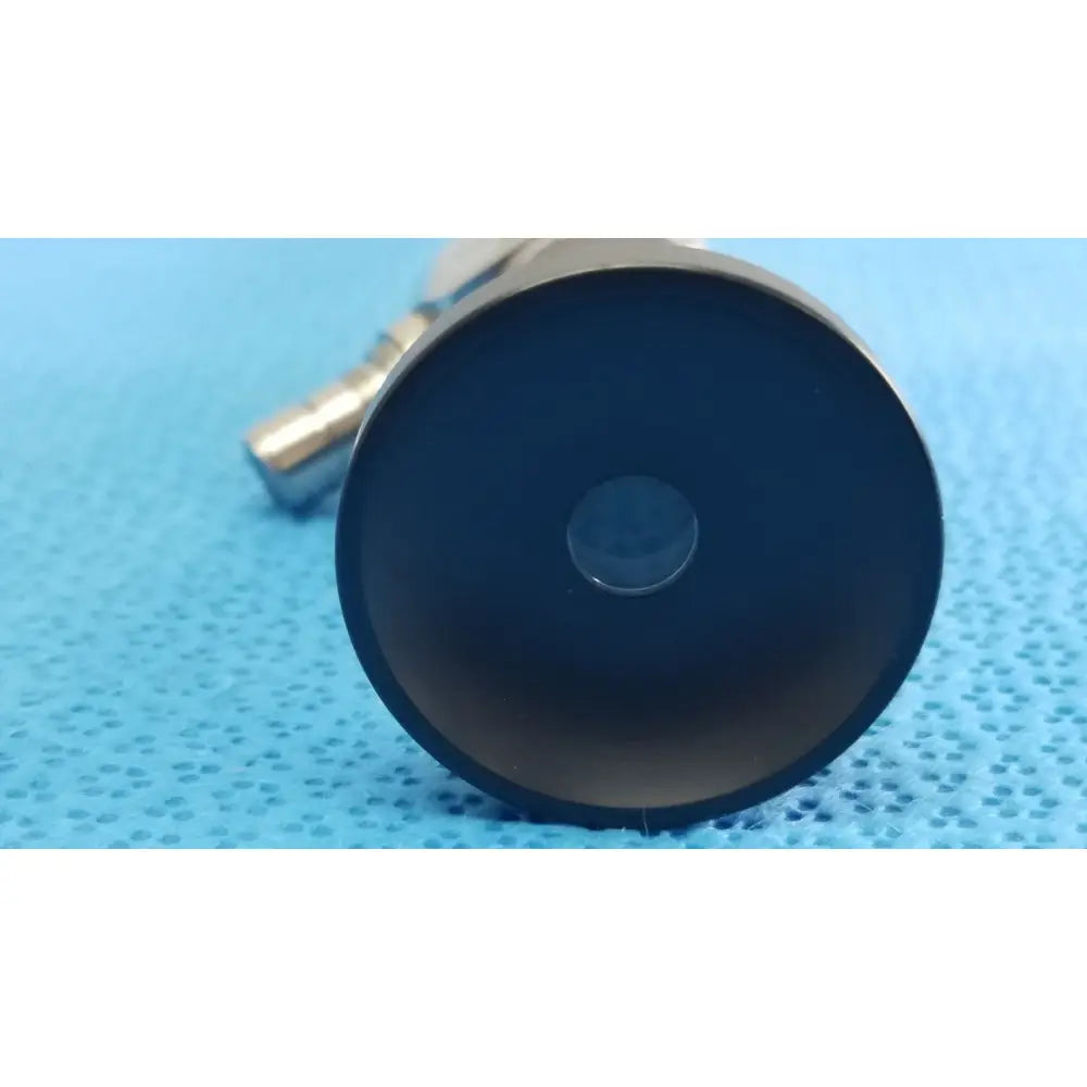Black circular lens with central aperture in metallic housing of novadaq sc9104 autoclavable laparoscope endoscope
