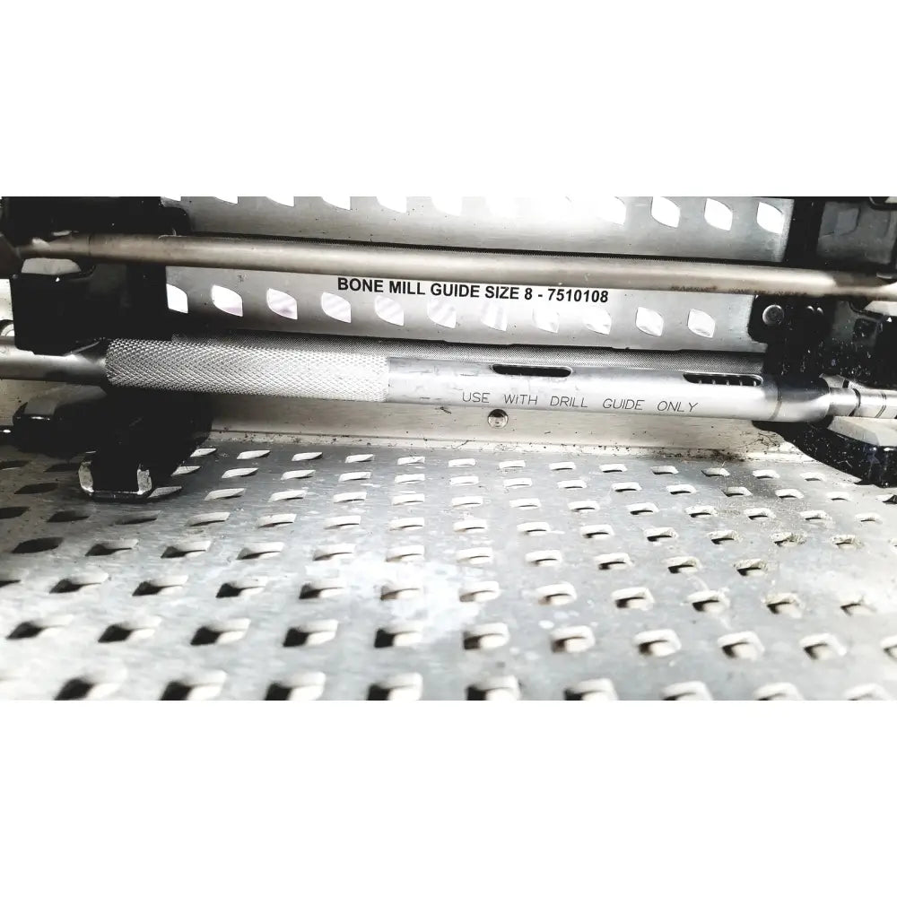 Silver metallic bone mill guide with textured grip and engraved markings for precise drilling in nuvasive speed innovation coroent xl-fixation tray
